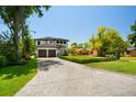 Spacious front yard featuring a lush lawn and a charming two-story home with two-car garage at 6564 Lagoon St, Windermere, FL 34786