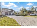 Modern two-story home with a long driveway and landscaped front yard at 6564 Lagoon St, Windermere, FL 34786