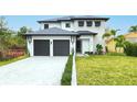 Two-story modern home with dark gray roof and two-car garage at 6564 Lagoon St, Windermere, FL 34786