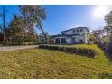 House with a paved driveway and manicured lawn at 6564 Lagoon St, Windermere, FL 34786