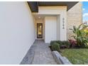 Close up of the home's entry featuring manicured landscaping and the home's address at 6564 Lagoon St, Windermere, FL 34786
