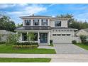 Charming two-story home with a manicured lawn, a paved driveway, and a beautiful front door and shutters at 809 Maxwell St, Orlando, FL 32804