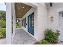 View of the house's entryway with a blue double door, wooden ceiling and white brick walls at 809 Maxwell St, Orlando, FL 32804