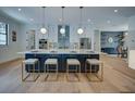 Bright kitchen boasts a large center island, stainless steel appliances, and pendant lighting, perfect for entertaining at 809 Maxwell St, Orlando, FL 32804