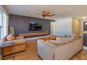 Living room with hardwood floors, a large TV, and comfortable seating at 1354 Tierra Cir, Winter Park, FL 32792
