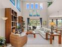 Spacious living room with high ceilings, large windows, and comfortable seating at 14442 Avenue Of The Rushes, Winter Garden, FL 34787