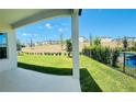 A spacious backyard offers views of a well-maintained lawn and neighboring houses against a clear blue sky at 16337 Silver Grove Blvd, Winter Garden, FL 34787