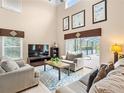 Large living room with high ceilings, couches, and access to a pool at 2119 Victoria Dr, Davenport, FL 33837