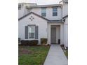 Front view of a two-story townhome with gray door at 236 Captiva Dr, Davenport, FL 33896