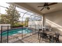Relaxing screened-in pool area perfect for outdoor dining, complete with a barbecue and table set at 236 Captiva Dr, Davenport, FL 33896
