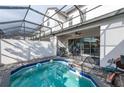 Tranquil screened-in pool and patio offer a private retreat with space for outdoor dining and relaxation at 236 Captiva Dr, Davenport, FL 33896