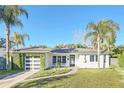 Mid-century modern home with a renovated exterior and tropical landscaping at 3809 Pelican Lane, Orlando, FL 32803