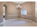 Bright dining room with a chandelier and tile floors at 38633 Lakeview Walk, Lady Lake, FL 32159