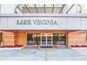 Main entrance to Lake Virginia with welcoming landscaping and signage at 690 Osceola Ave # 209, Winter Park, FL 32789