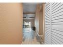 Bright hallway with wood-look tile floors leading to living area and patio at 734 E Michigan St # 113, Orlando, FL 32806
