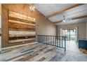 Open living room with wood-look floors and access to backyard patio at 734 E Michigan St # 113, Orlando, FL 32806