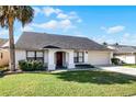 Single-story home with gray roof, attached garage, and neatly landscaped front yard at 783 Tomlinson Ter, Lake Mary, FL 32746