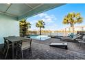 Patio with table and chairs overlooking pool and lake at 8137 Surf St, Kissimmee, FL 34747