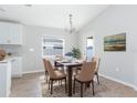 Dining area with a wood table, six chairs, and a neutral-toned rug at 878 Galloway St, Lake Alfred, FL 33850