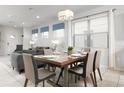 Dining area with a modern wooden table and gray chairs at 9009 Rhodes St, Kissimmee, FL 34747