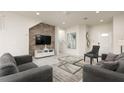 Living room featuring gray sofas, a coffee table, and a large TV at 9009 Rhodes St, Kissimmee, FL 34747