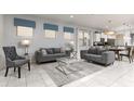 Spacious living room with gray sofas and a glass coffee table at 9009 Rhodes St, Kissimmee, FL 34747