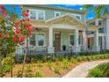 Charming two-story home with a welcoming front porch and lush landscaping at 931 Kylee Aly, Winter Garden, FL 34787