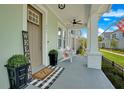 Inviting front porch with seating, welcome sign, and potted plants at 931 Kylee Aly, Winter Garden, FL 34787