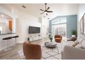 Open concept living room, featuring hardwood floors and a view to the kitchen at 10050 Hidden Dunes Ln, Orlando, FL 32832