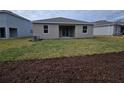 Newly constructed home with a large backyard and mulch beds at 1123 Happy Forest Loop, Deland, FL 32720