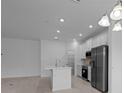 Bright kitchen featuring stainless steel appliances, a kitchen island, and an open concept design at 1123 Happy Forest Loop, Deland, FL 32720