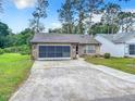 Cute brick ranch home with screened garage at 120 Crooked Pine Rd, Port Orange, FL 32128
