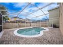 Kidney-shaped pool with a screened enclosure at 1266 Sandestin Way, Orlando, FL 32824