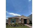 Front view of a one-story house with a teal door and landscaping at 16704 Point Rock Dr, Winter Garden, FL 34787
