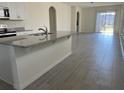 Open kitchen features granite countertops and stainless steel appliances at 16704 Point Rock Dr, Winter Garden, FL 34787