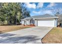 Front view of a gray house with a concrete driveway at 17 Walnut Crse, Ocala, FL 34480