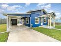 Newly painted blue house with carport and a small front yard at 205 9Th St, St Cloud, FL 34769