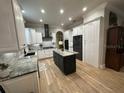 Well-lit kitchen featuring an island, modern appliances and abundant cabinet space at 205 Hazard St, Orlando, FL 32804