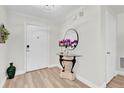 Bright and airy entryway with a glass-top table and mirror at 211 Lynn St, Oviedo, FL 32765