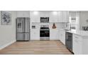 Modern kitchen featuring stainless steel appliances and white shaker cabinets at 211 Lynn St, Oviedo, FL 32765