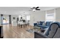Open living room with L-shaped sectional sofa and hardwood floor at 211 Lynn St, Oviedo, FL 32765