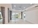 Bright living room with tile flooring, recessed lighting, and sliding glass doors to the patio at 240 Blue Starfish Pl, Daytona Beach, FL 32124