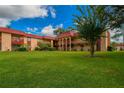 Building exterior showcasing landscaping and a grassy area at 2858 N Powers Dr # 123, Orlando, FL 32818