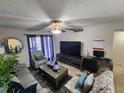 Living room featuring a large TV, comfortable seating, and a coffee table at 2858 N Powers Dr # 123, Orlando, FL 32818