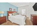 Spacious bedroom with a wooden bed frame and light-colored walls at 2956 Lucayan Harbour Cir # 107, Kissimmee, FL 34746