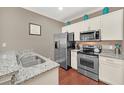 Modern kitchen featuring stainless steel appliances and granite countertops at 2956 Lucayan Harbour Cir # 107, Kissimmee, FL 34746