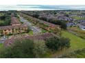 Aerial view of a community of tan and blue townhouses at 3428 Calabria Ave, Davenport, FL 33897