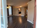 Open living room with dark hardwood floors and a view of the kitchen at 371 Lexingdale Dr, Orlando, FL 32828