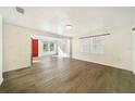 Spacious living area with wood-look floors and an open floor plan at 4935 Sand Mountain Loop Rd, Auburndale, FL 33823