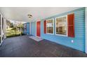 Screened porch with tile flooring and access to the front door at 4935 Sand Mountain Loop Rd, Auburndale, FL 33823